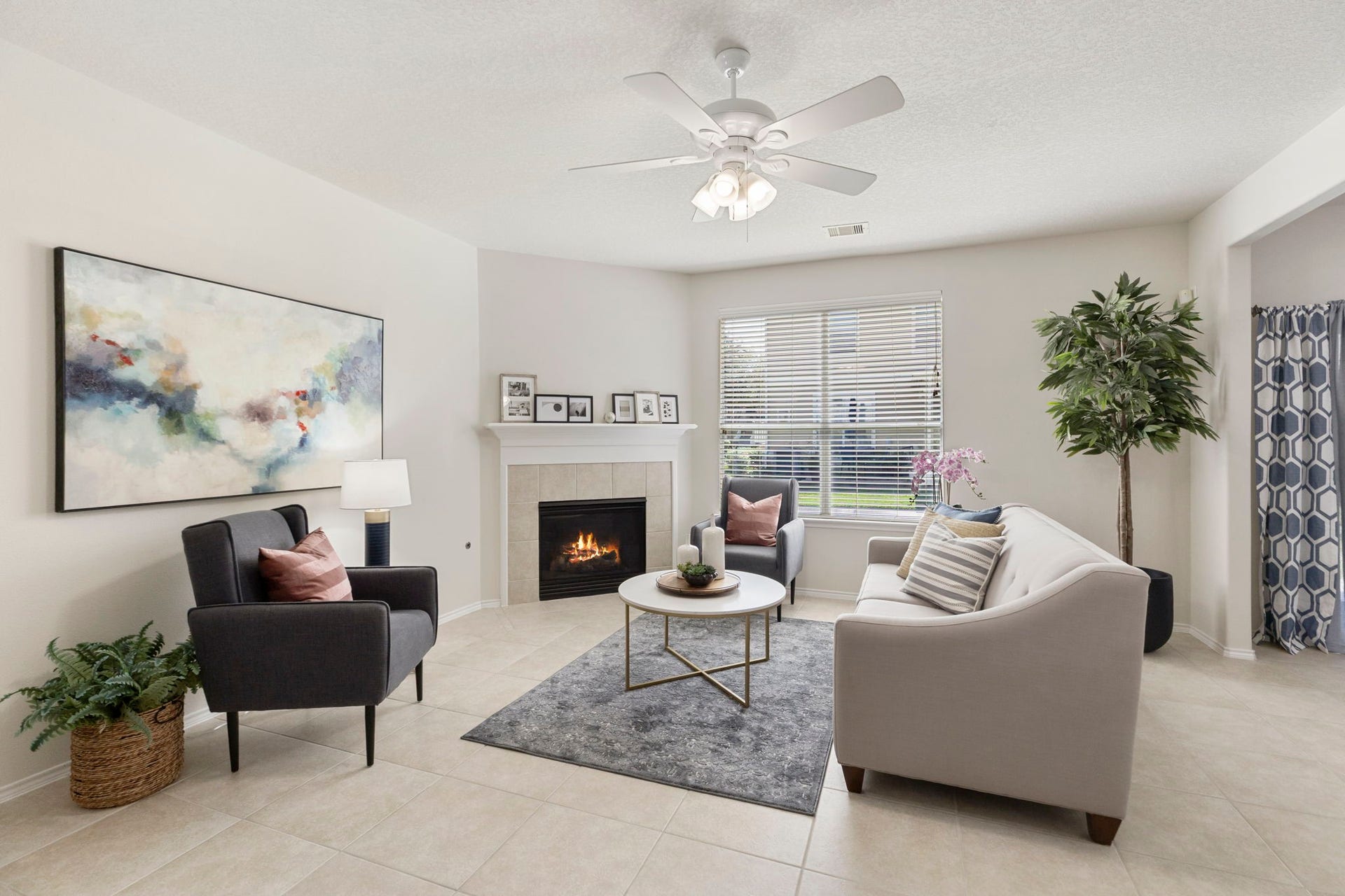 13600 Breton Ridge Street, #11A, Houston, TX 77070 Bright and inviting living room with a corner gas log fireplace, fresh neutral paint, and abundant natural light.