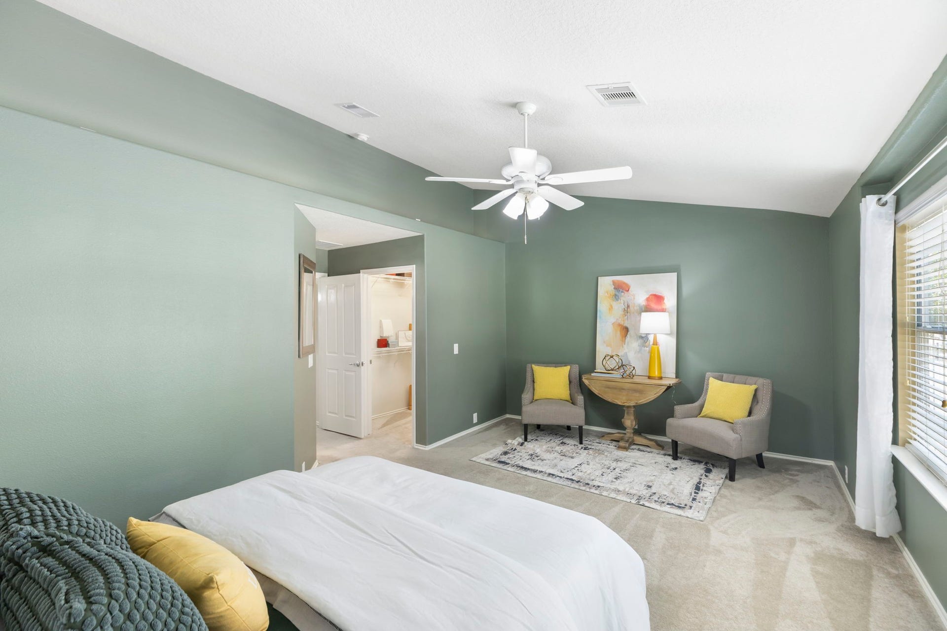13600 Breton Ridge Street, #11A, Houston, TX 77070 This primary bedroom is thoughtfully designed to create a serene getaway. The room is freshly painted with a soothing green palette and accent LED lighting on the ledge to create a relaxed and romantic mood.