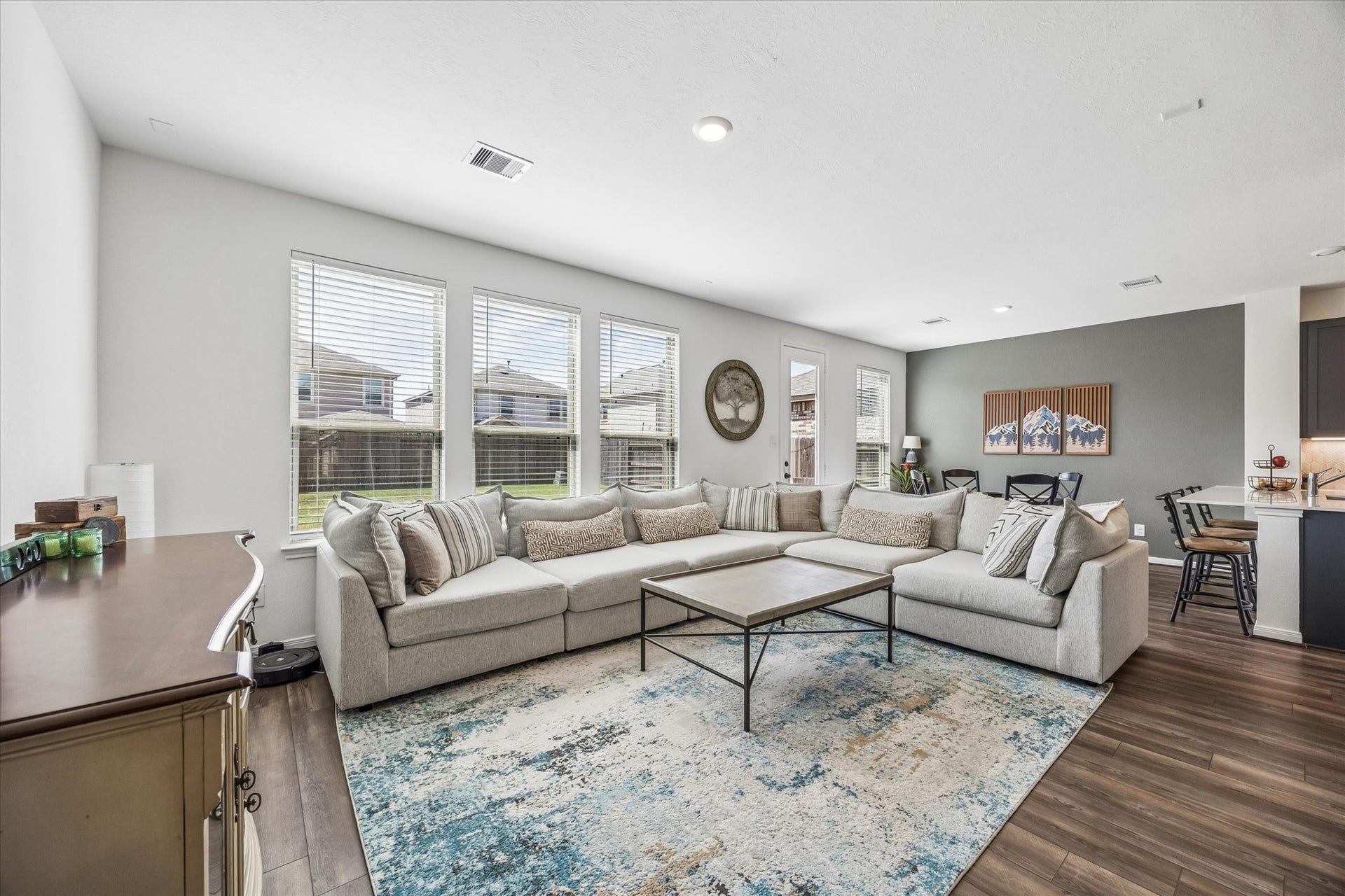 2852 Grand Anse Drive, Katy, TX 77493 Spacious, light-filled living area with abundance of natural light and an open-concept layout that flows seamlessly into the dining and kitchen area