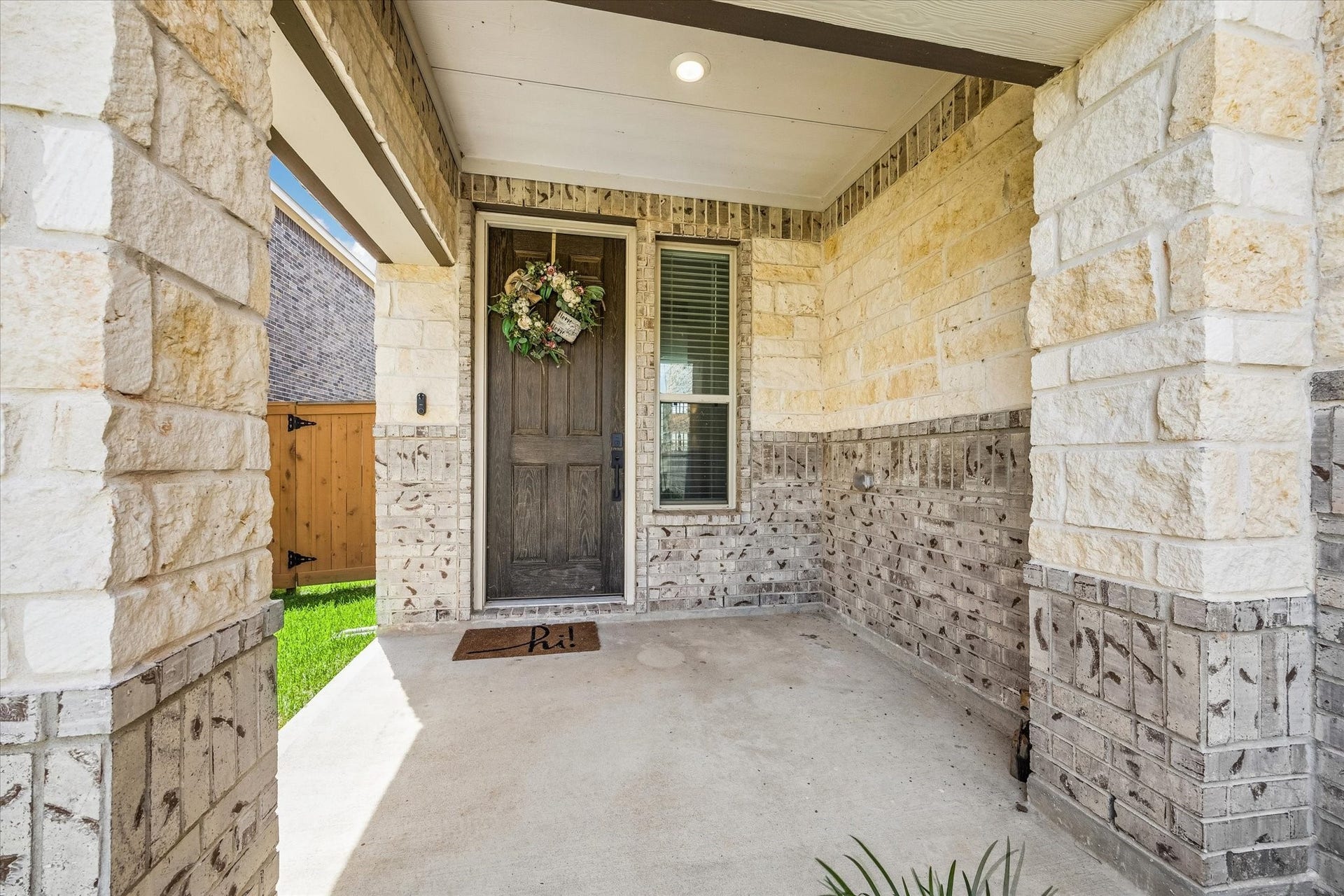 2852 Grand Anse Drive, Katy, TX 77493 Welcoming covered front porch with beautiful stone and brick detailing, creating a warm and inviting entry to the home.