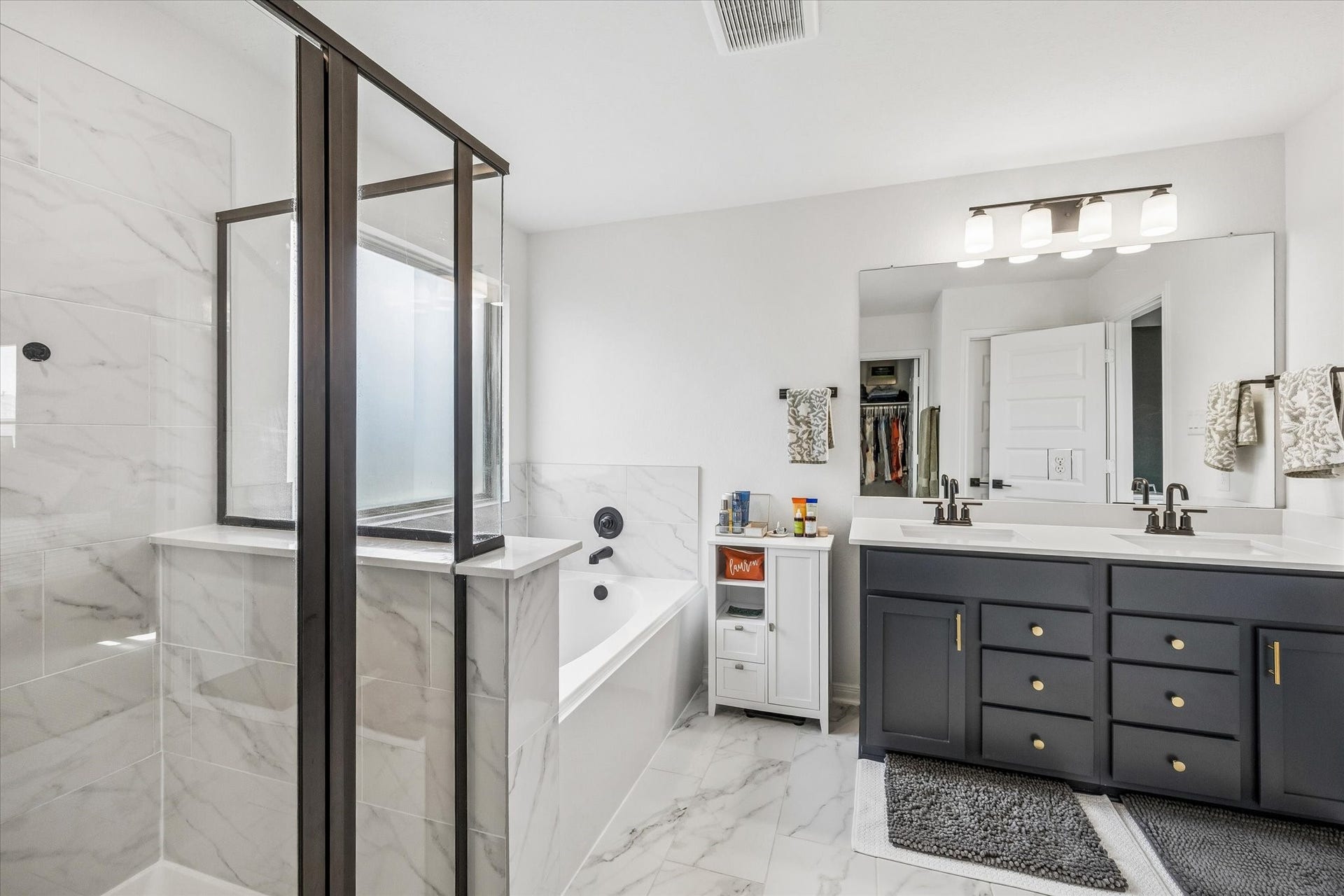 2852 Grand Anse Drive, Katy, TX 77493 Additional view of the primary en-suite showcasing the separate tub and shower, expansive vanity, and bright, open layout.