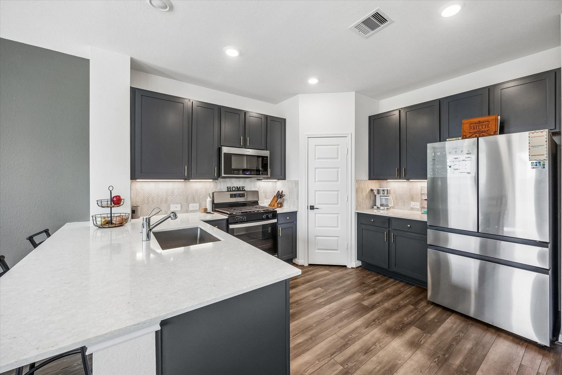2852 Grand Anse Drive, Katy, TX 77493 Functional kitchen layout with an oversized island, abundant storage, and plenty of prep space for cooking and gathering.