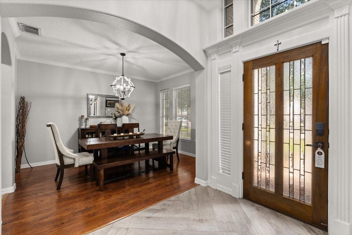 2437 La Rochelle Court, Seabrook, TX 77586 Welcoming foyer opens into the formal dining room beneath a graceful architectural arch.