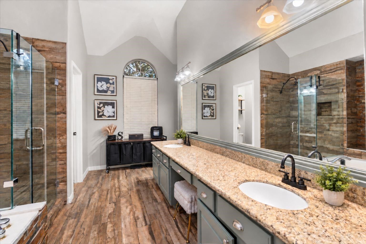 2437 La Rochelle Court, Seabrook, TX 77586 The primary bathroom includes an extended dual-sink vanity, granite counters, and dark fixtures.