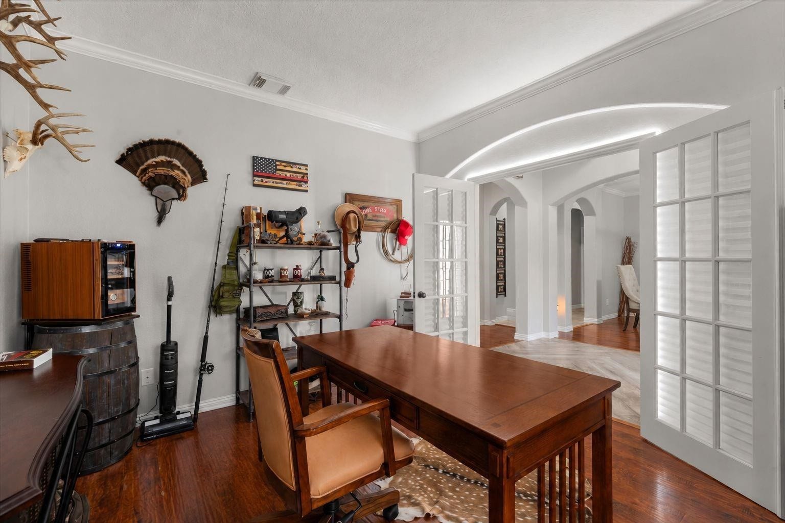 2437 La Rochelle Court, Seabrook, TX 77586 Private home office with French doors, wood flooring, and an attractive arched entry.
