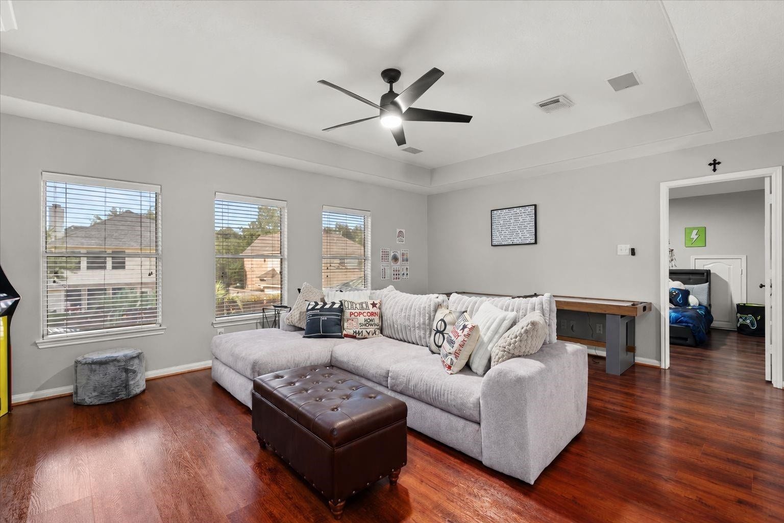 2437 La Rochelle Court, Seabrook, TX 77586 Spacious upstairs game room features wood flooring, a tray ceiling, and flexible entertaining space.