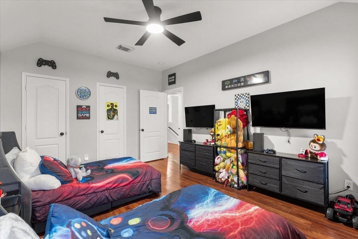2437 La Rochelle Court, Seabrook, TX 77586 Another bedroom perspective highlights the room size, wood flooring, and storage furnishings.