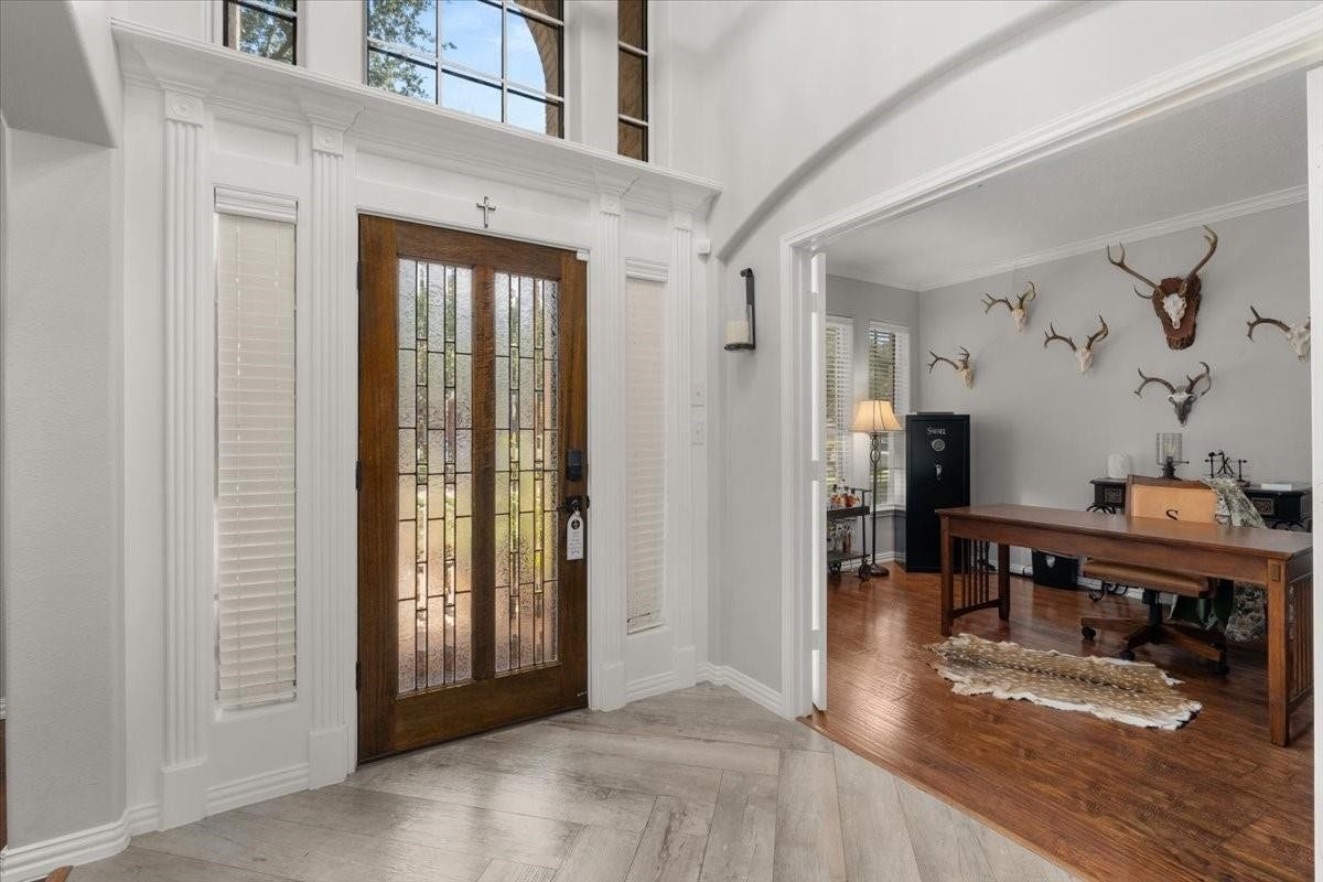 2437 La Rochelle Court, Seabrook, TX 77586 Soaring entry with decorative glass front doors, detailed trim work, and an adjoining study.