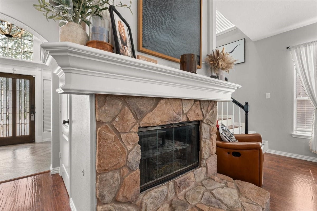 2437 La Rochelle Court, Seabrook, TX 77586 A striking stone fireplace with a substantial white mantel anchors the family room.