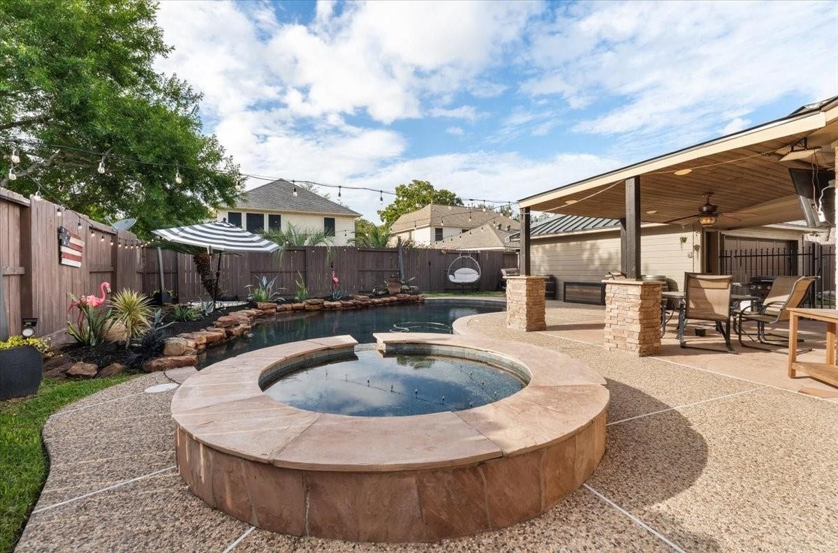 2437 La Rochelle Court, Seabrook, TX 77586 Raised spa with an expansive surrounding patio and views of the adjoining swimming pool.