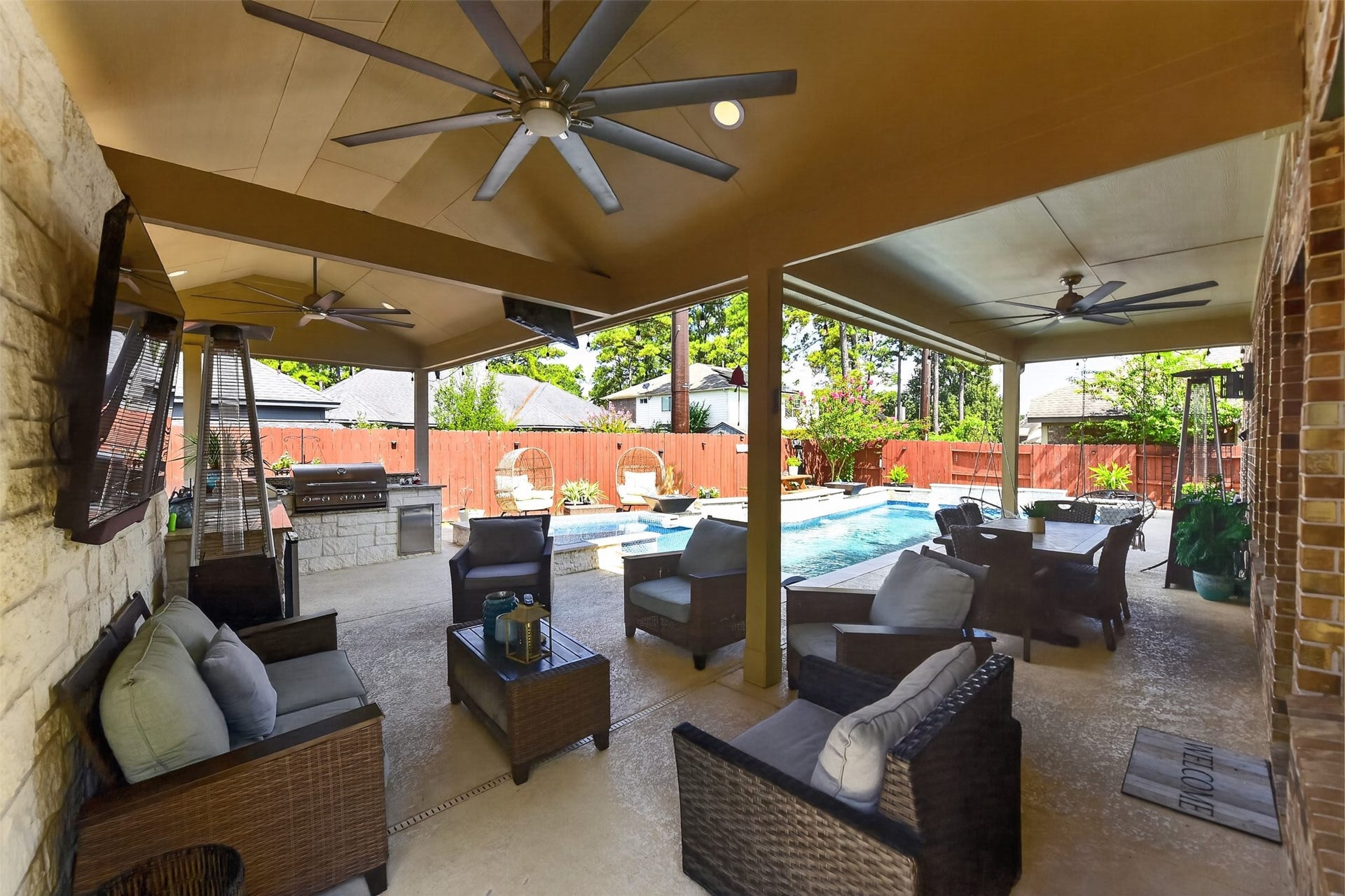 Expansive outside patio with a kitchen and pool!