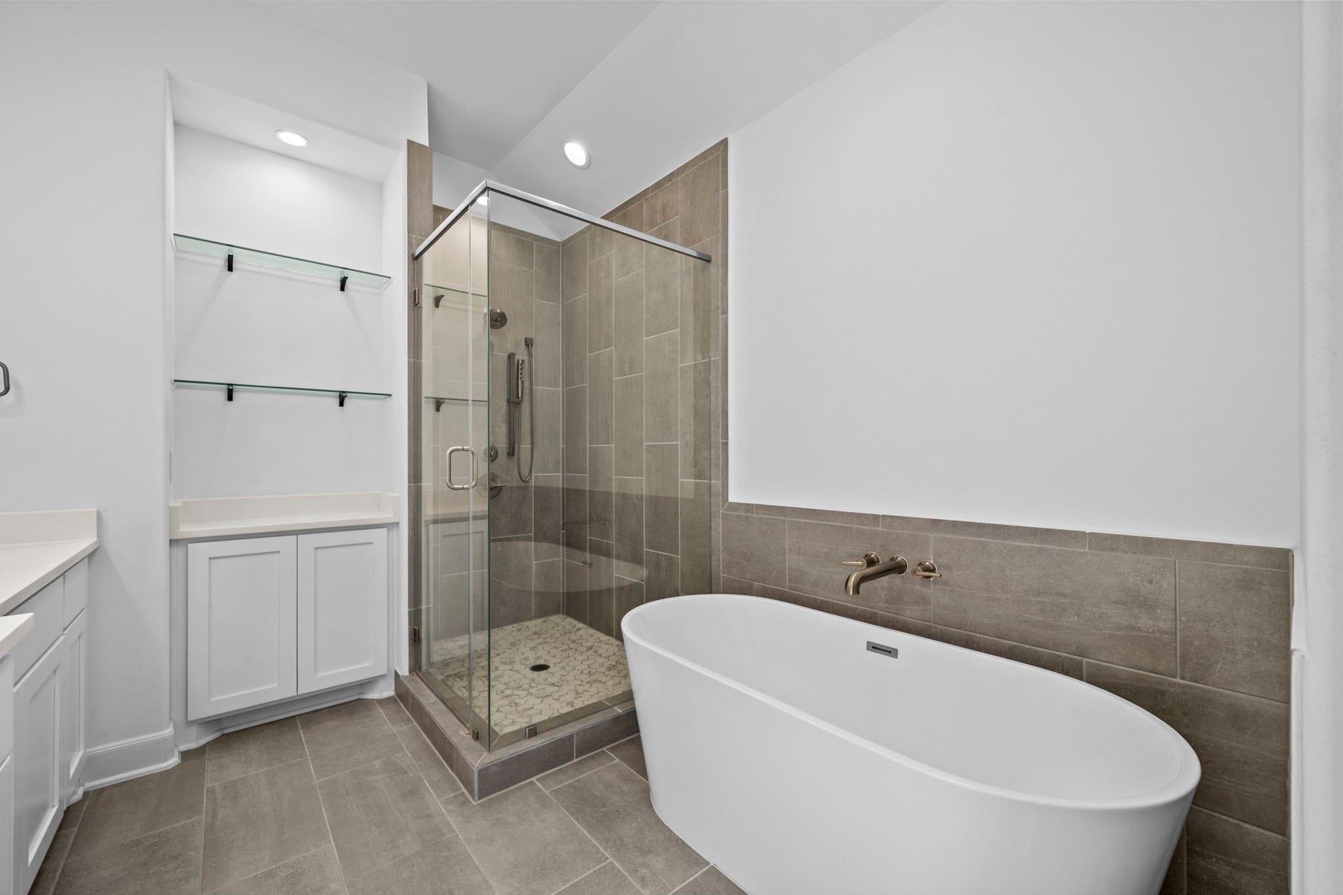 1128 Malone Street, Houston, TX 77007 The primary bathroom continues with an oversized walk-in shower and freestanding soaking tub. The combination creates a strong spa-style feature within the suite.