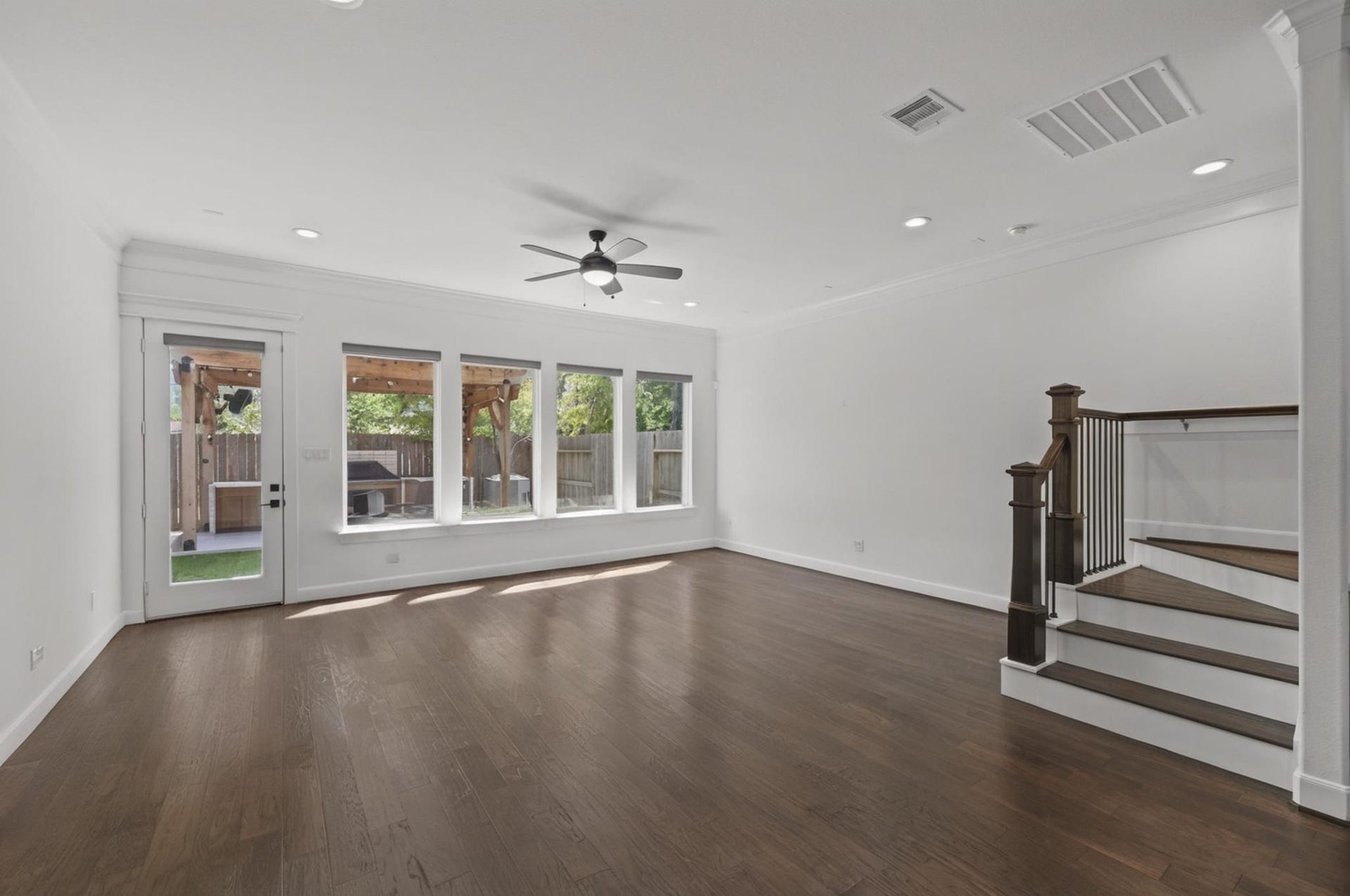 1128 Malone Street, Houston, TX 77007 The empty living room shows the full scale of the first-floor layout, including the wide wall space, staircase placement, and open sightlines. The room is clean, bright, and easy to furnish.