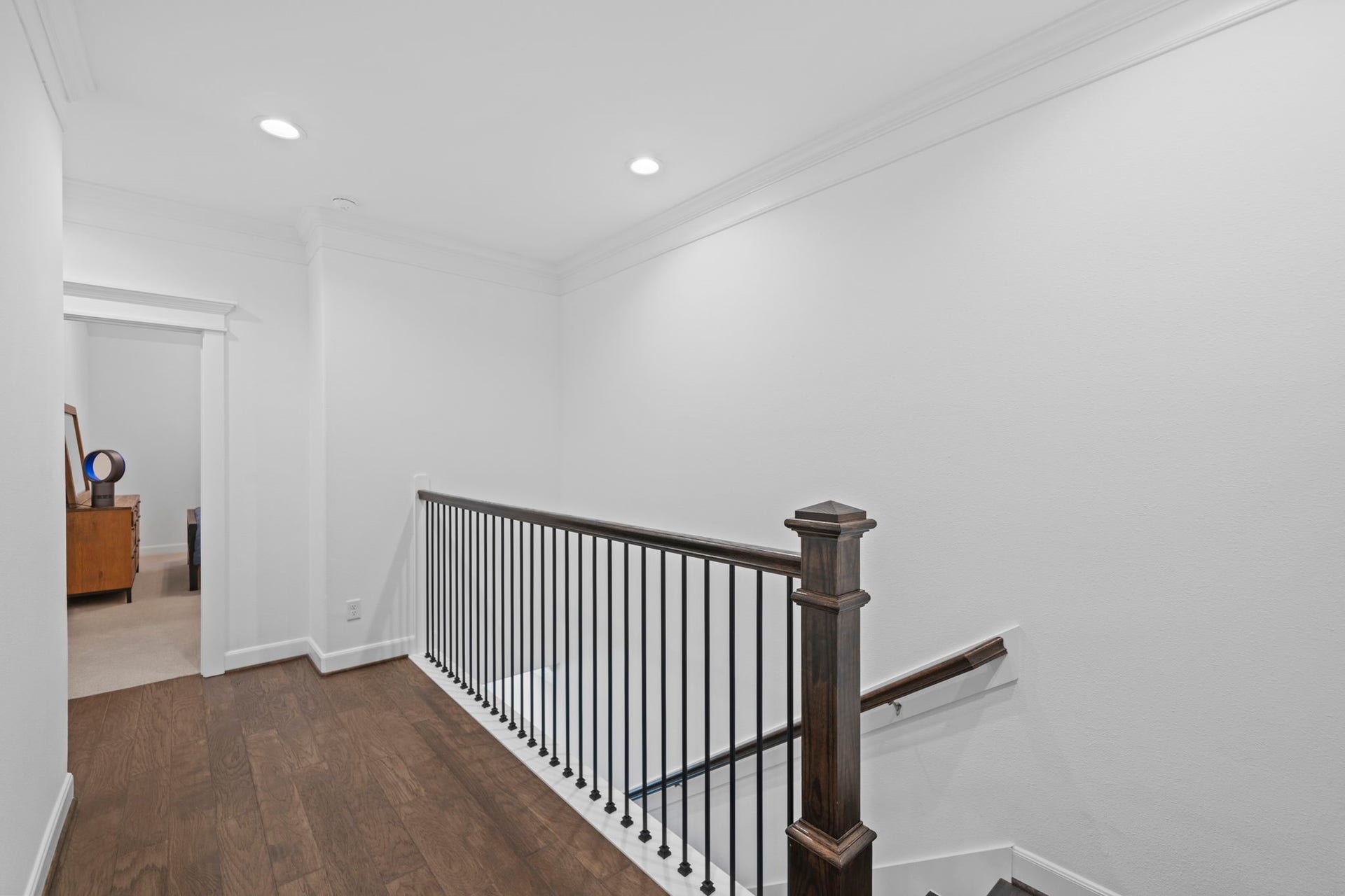 1128 Malone Street, Houston, TX 77007 The upstairs landing creates a clean transition between the bedrooms, game room, utility space, and primary suite. The open railing detail adds light and connection between levels.