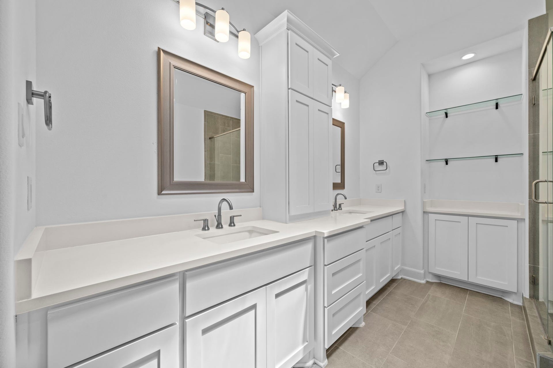 1128 Malone Street, Houston, TX 77007 The primary bath begins with a bright double-sink vanity and clean custom finishes. The layout gives the suite a polished, spa-like start.
