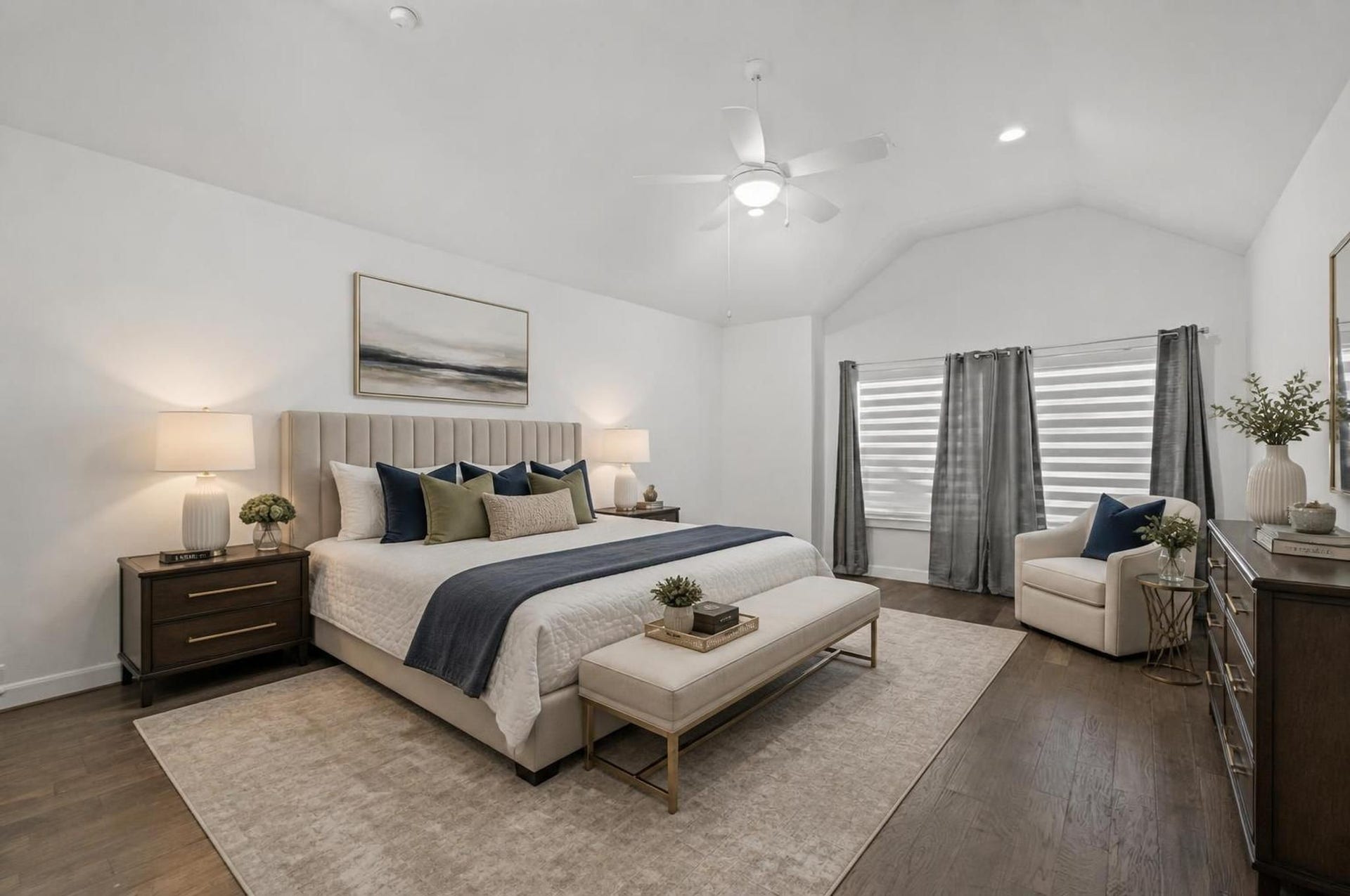 1128 Malone Street, Houston, TX 77007 The primary bedroom offers generous scale with vaulted ceilings and a calm upstairs setting. The room has space for a full bedroom setup while staying connected to the ensuite bath and closet. Virtually staged.
