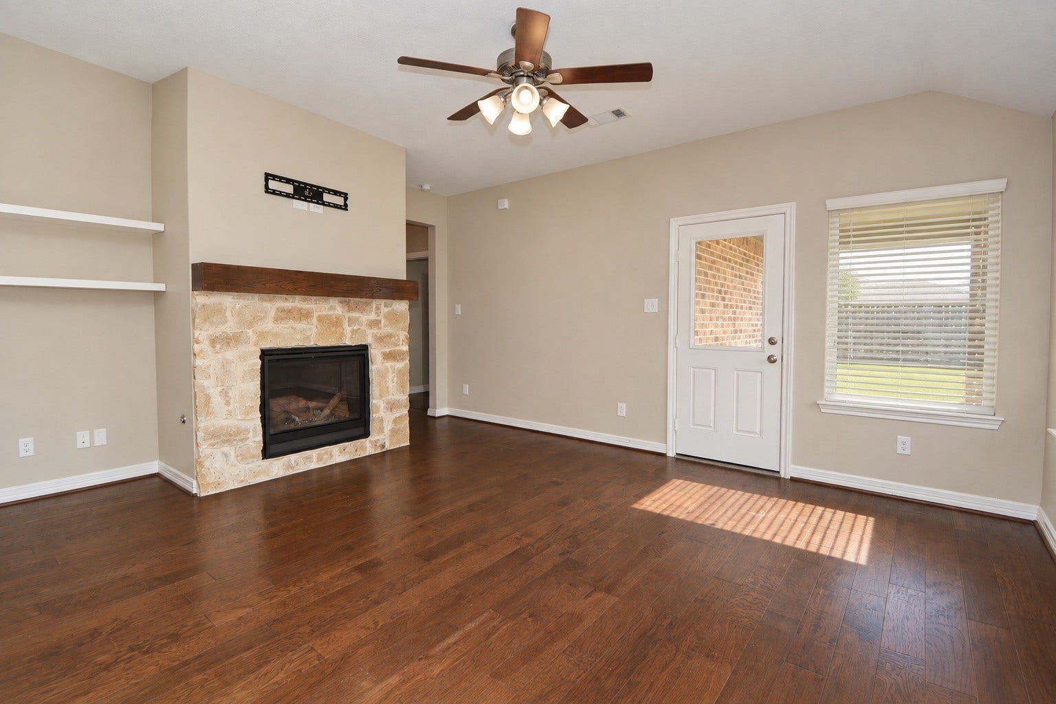 26322 Stonedale View Drive, Richmond, TX 77406 Living room featuring a warm fireplace and convenient access to the backyard