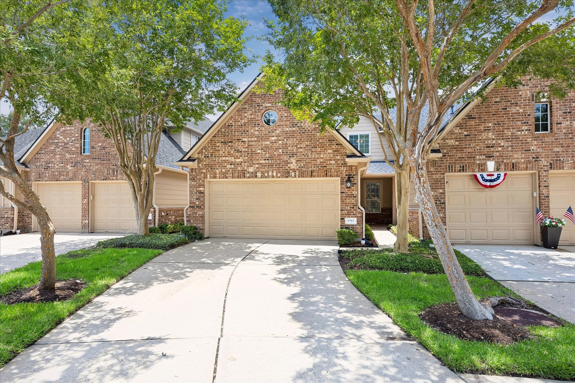 1711 QUIET POND DRIVE, Sugar Land, TX 77479 CHARMING BRICK ELEVATION WITH A 2-CAR GARAGE, MATURE TREES, AND INVITING CURB APPEAL.