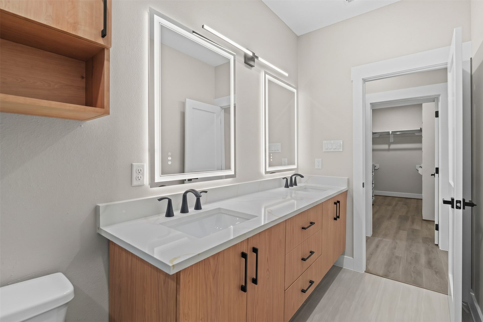 The functional floor plan offers excellent room clearance, seamlessly connecting the vanity zone directly to an adjoining walk-in closet.