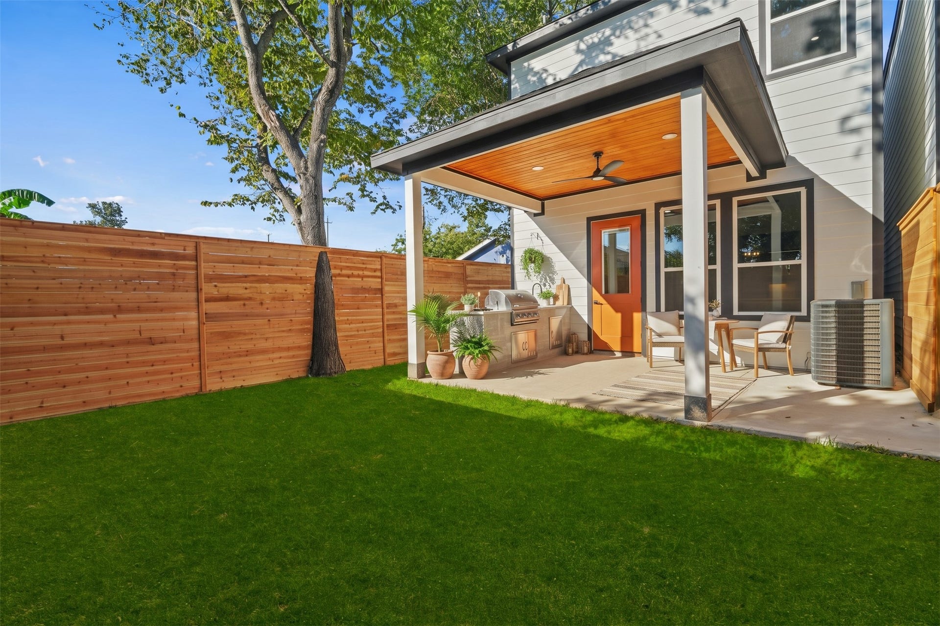 Virtually Staged: Designed for ideal indoor-outdoor living, this property showcases a well-sized grassy yard anchored by a covered outdoor terrace.