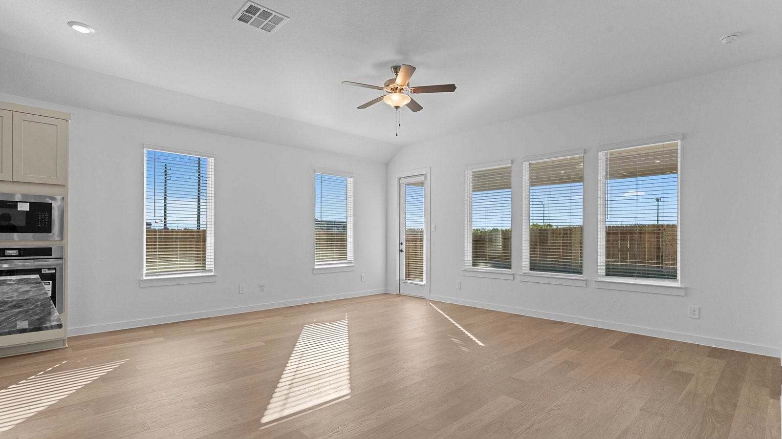14028 Pine Cliffs Drive, Texas City, TX 77568 A cozy living room featuring large windows for natural lighting, vinyl wood flooring and a view to the kitchen and dining area.
A cozy living room featuring large windows for natural lighting, vinyl wood flooring and a view to the kitchen and dining area.