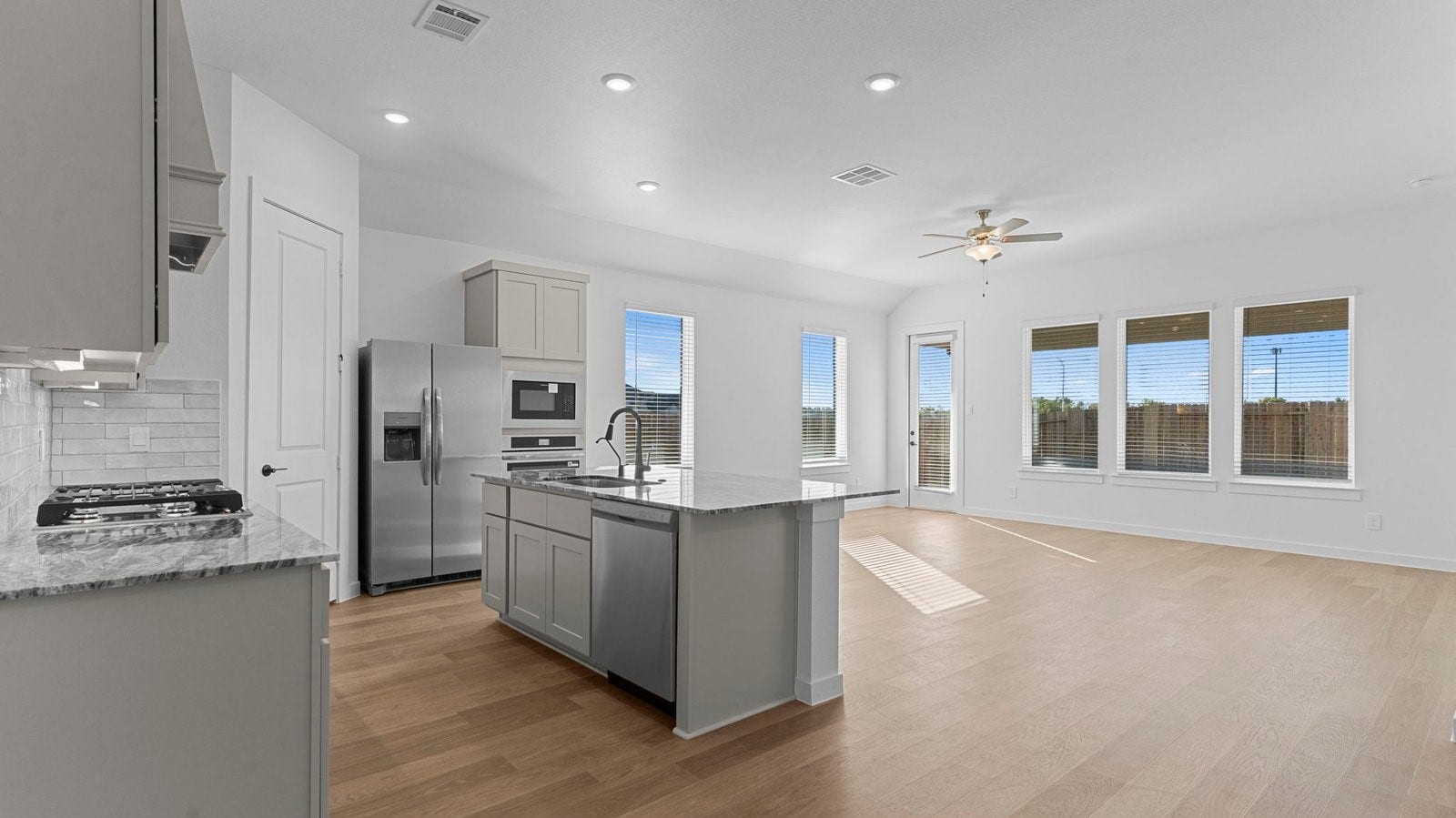 14028 Pine Cliffs Drive, Texas City, TX 77568 Bright and spacious kitchen with quartz countertops, stainless steel appliances, and an island with bar seating.