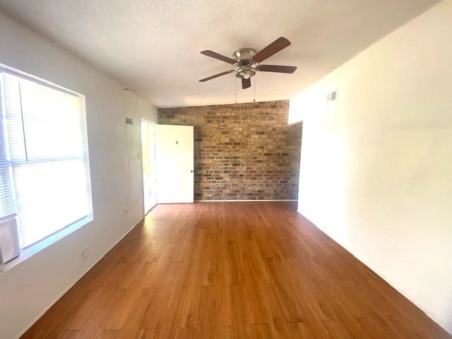 215 Avenue E, South Houston, TX 77587 The living room has an accent brick wall.