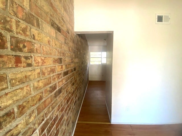 215 Avenue E, South Houston, TX 77587 The accent brick wall extends out to into the breakfast room.