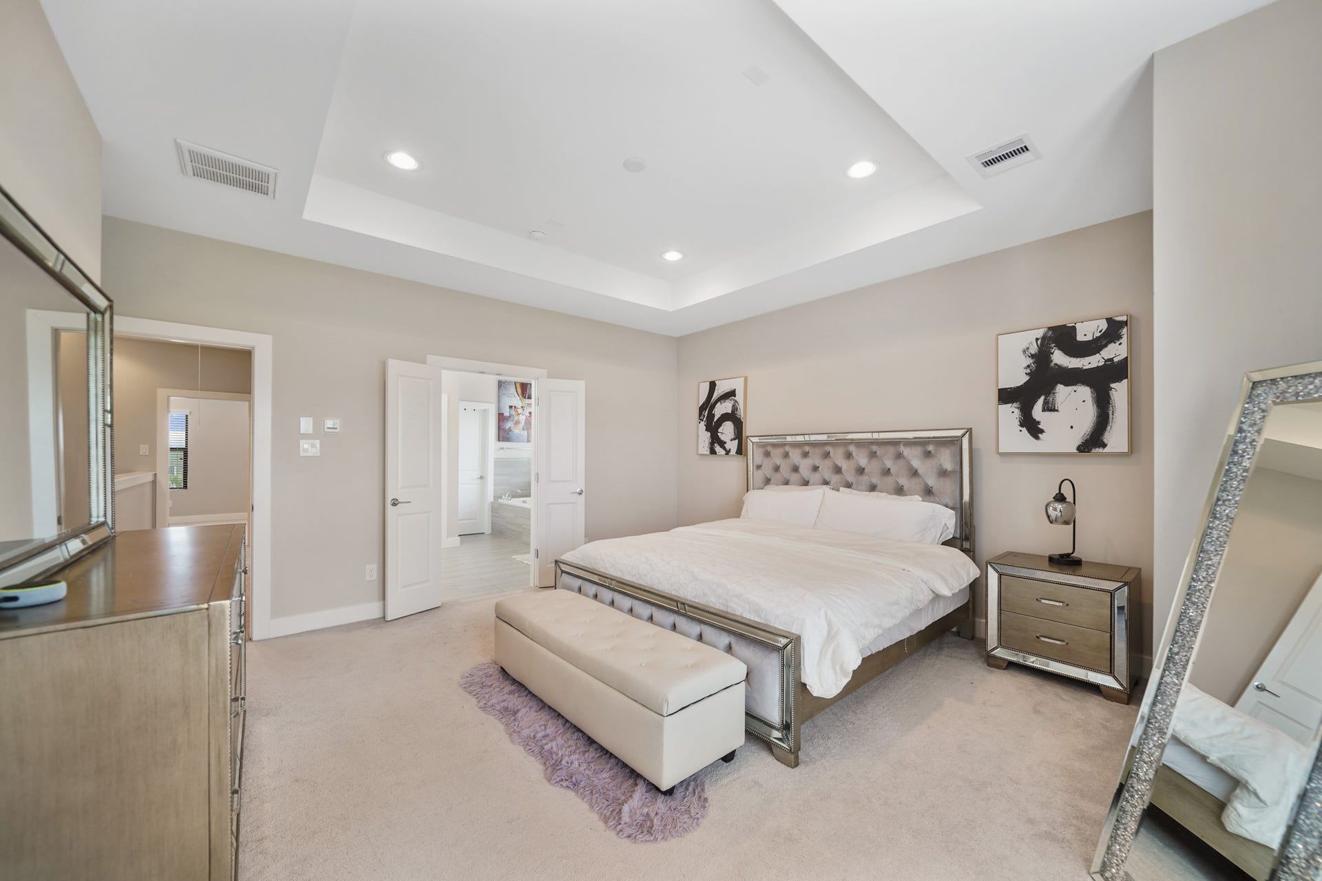 1824 Bonner Street, Houston, TX 77007 A view of the primary bedroom with the third floor corridor and access to a private bath shown in the background. The king size bed including frame & foam mattress can stay with the home along with the electronic mirror.