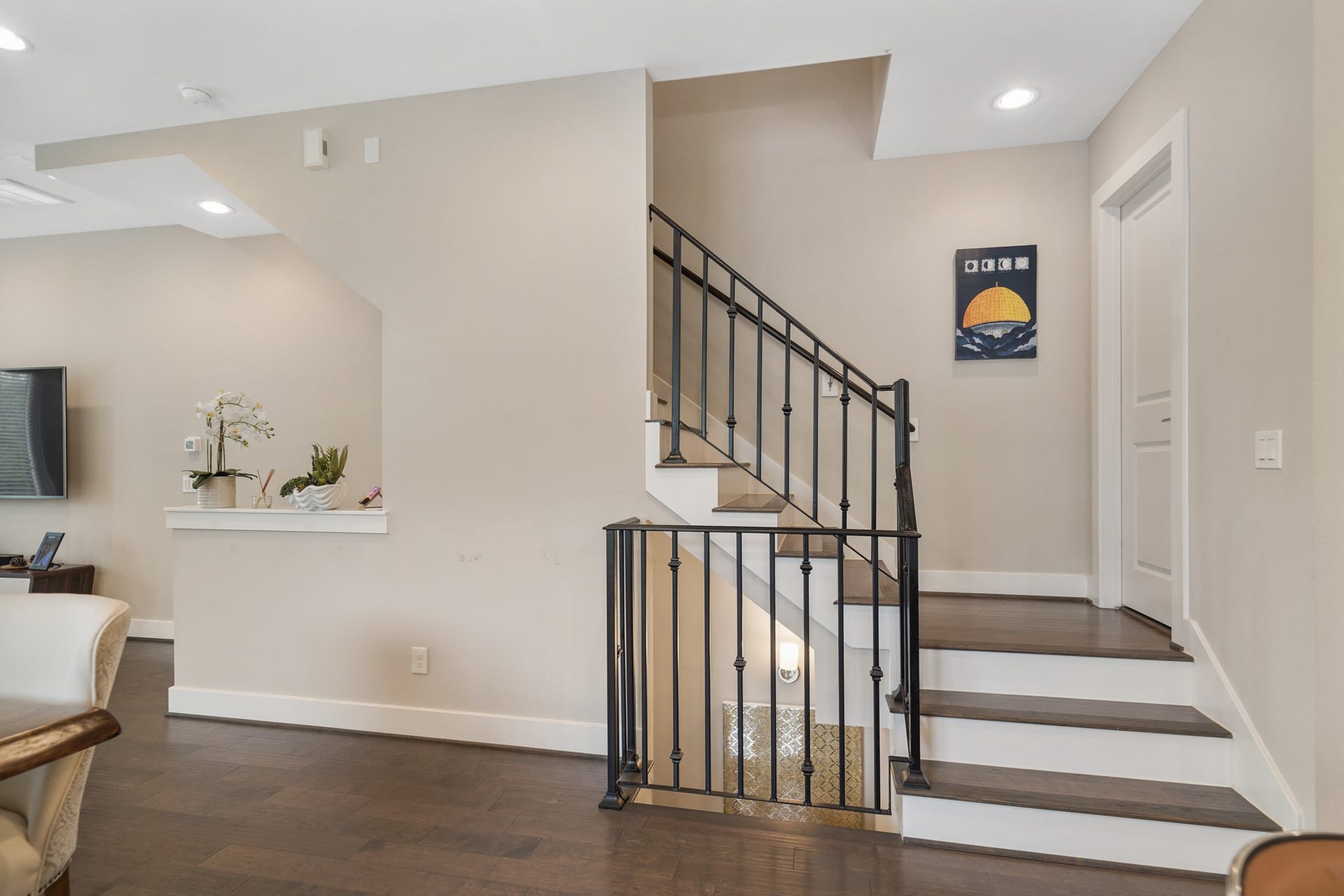 1824 Bonner Street, Houston, TX 77007 A wrought iron staircase leads to the third level of the home with a half bath accessible through the door on the right.