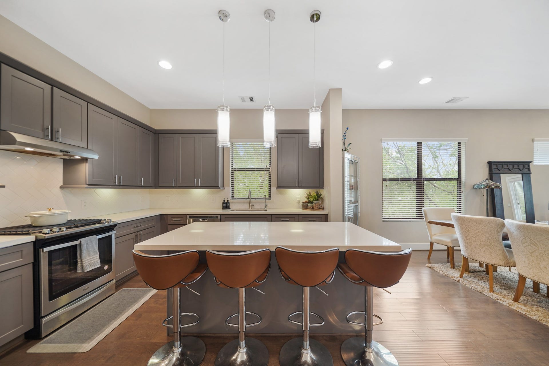 1824 Bonner Street, Houston, TX 77007 The centrally located island illuminated by pendant lighting offers breakfast bar seating and doubles as a serving bar. Included is a stainless steel beverage fridge tucked away just below the island.