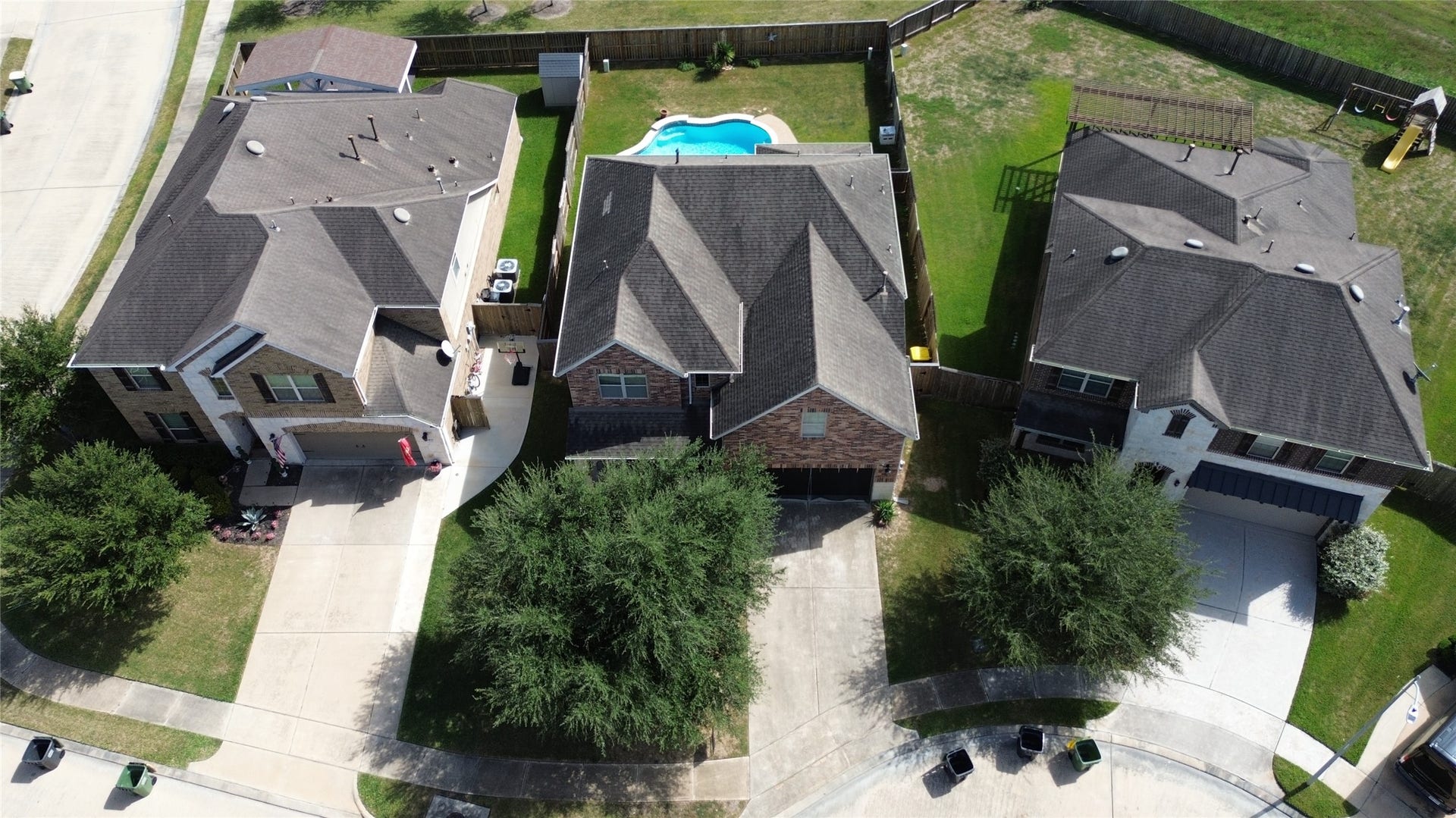 3913 Ginger Fields Court, Pearland, TX 77581 Drone view of pool, green space, and front access