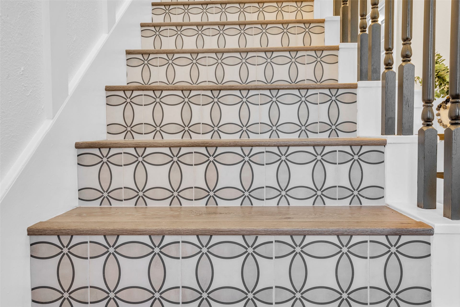 You are immediately greeted with the gorgeous pattern tiled stair risers upon entry, which is complimented by the wainscotting and statment chandelier