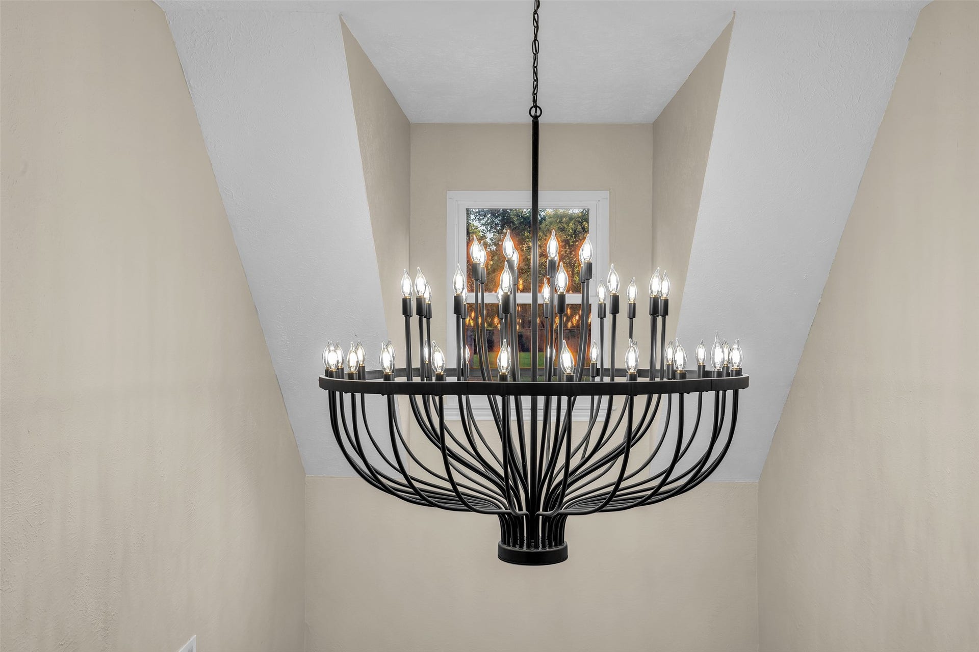 Stunning Chandelier in the entryway can be seen from the street.