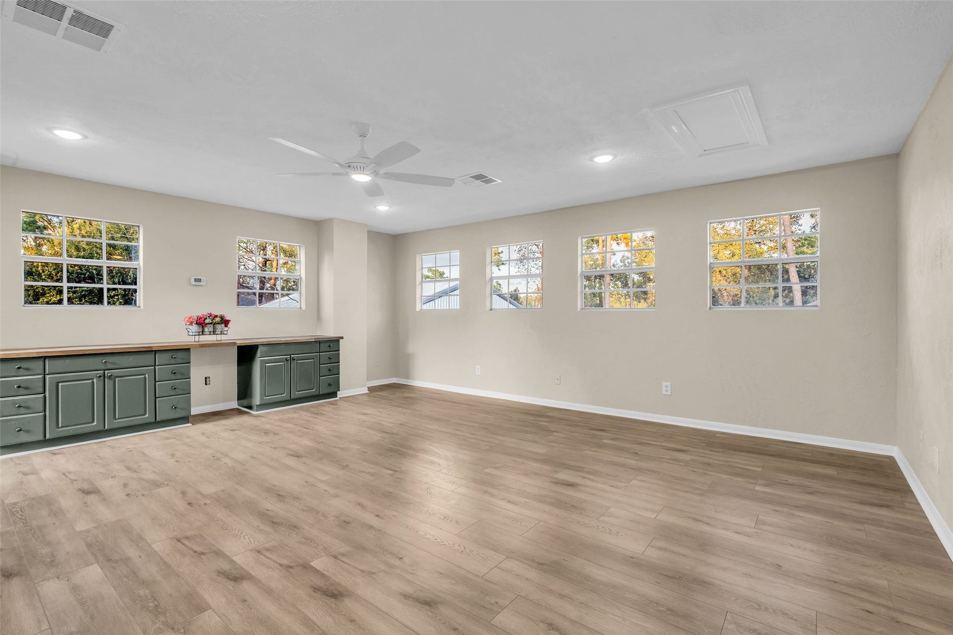 Bonus room above the garage approx 400 sq ft featuring cabinets and butcher clock countertop with perfect space for mini fridge. This space can be used as a game room, theatre room, gym or 5th bedroom with added closet storage. Perfect for the Multigenerational family living.