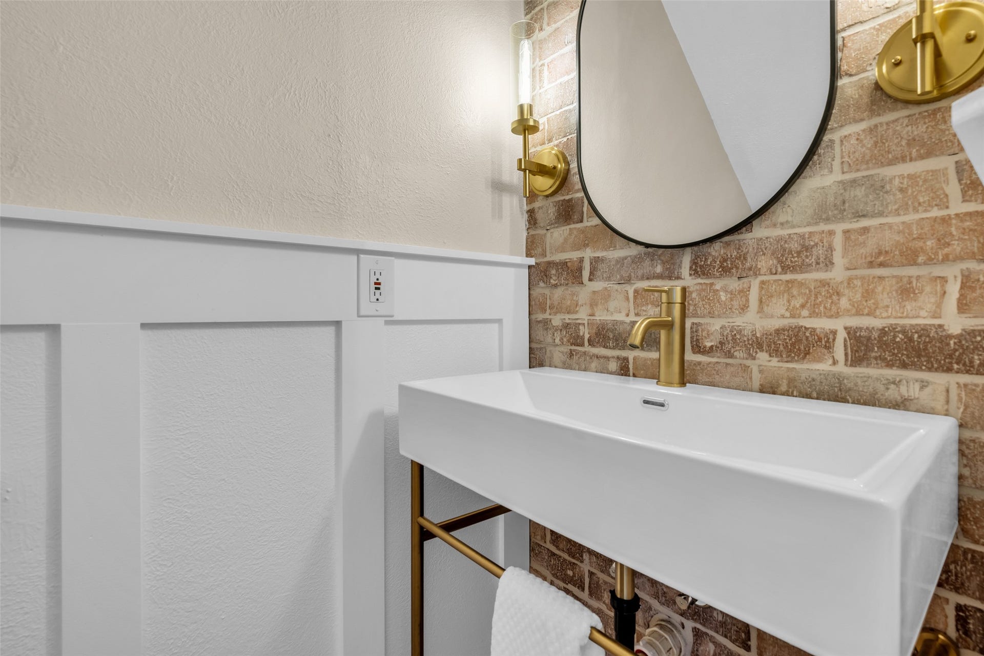 Stunning Half bath with exposed brick accent wall and custom sink