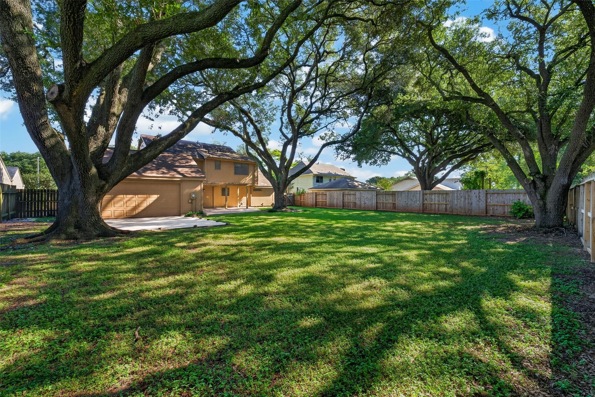 3119 Villa Lane, Missouri City, TX 77459 Garage has an overhead door at the rear that accesses the concrete pad.