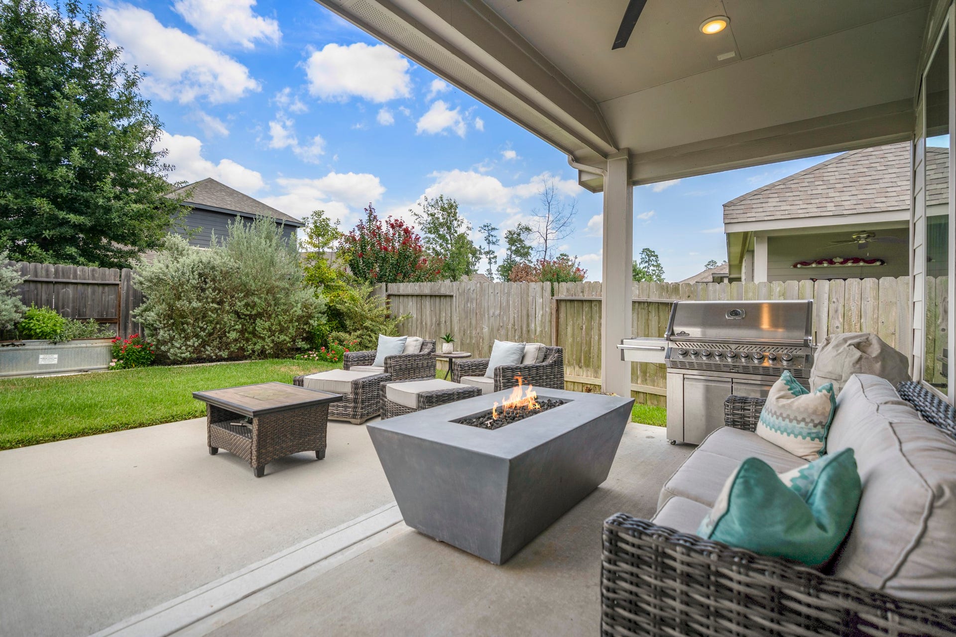 Covered patio with extended concrete provides extra room for entertaining! Backyard features full sprinkler with specialized drip system for the garden.