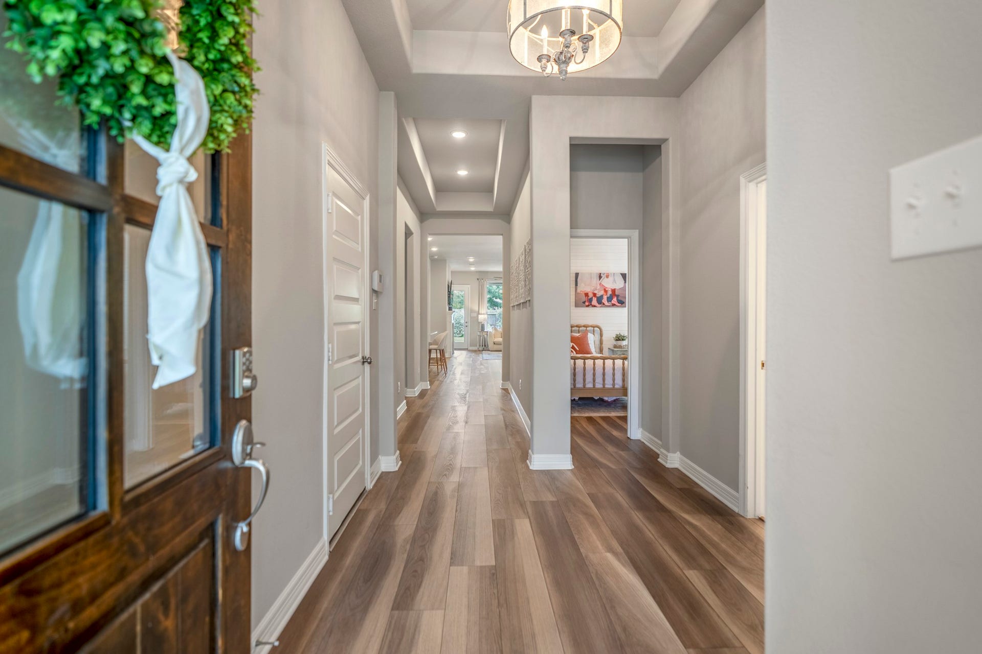 It's all in the details of this home. Front to back sightline is highlighted with the tray ceilings, lvp flooring throughout and timeless neutral color palette.