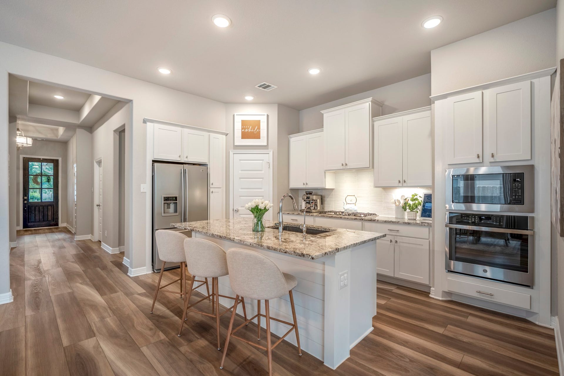 Gourmet kitchen with classic white shaker cabinets, timeless granite countertops, walk-in pantry and a fantastic flow. Love the bonus cabinet near refrigerator!