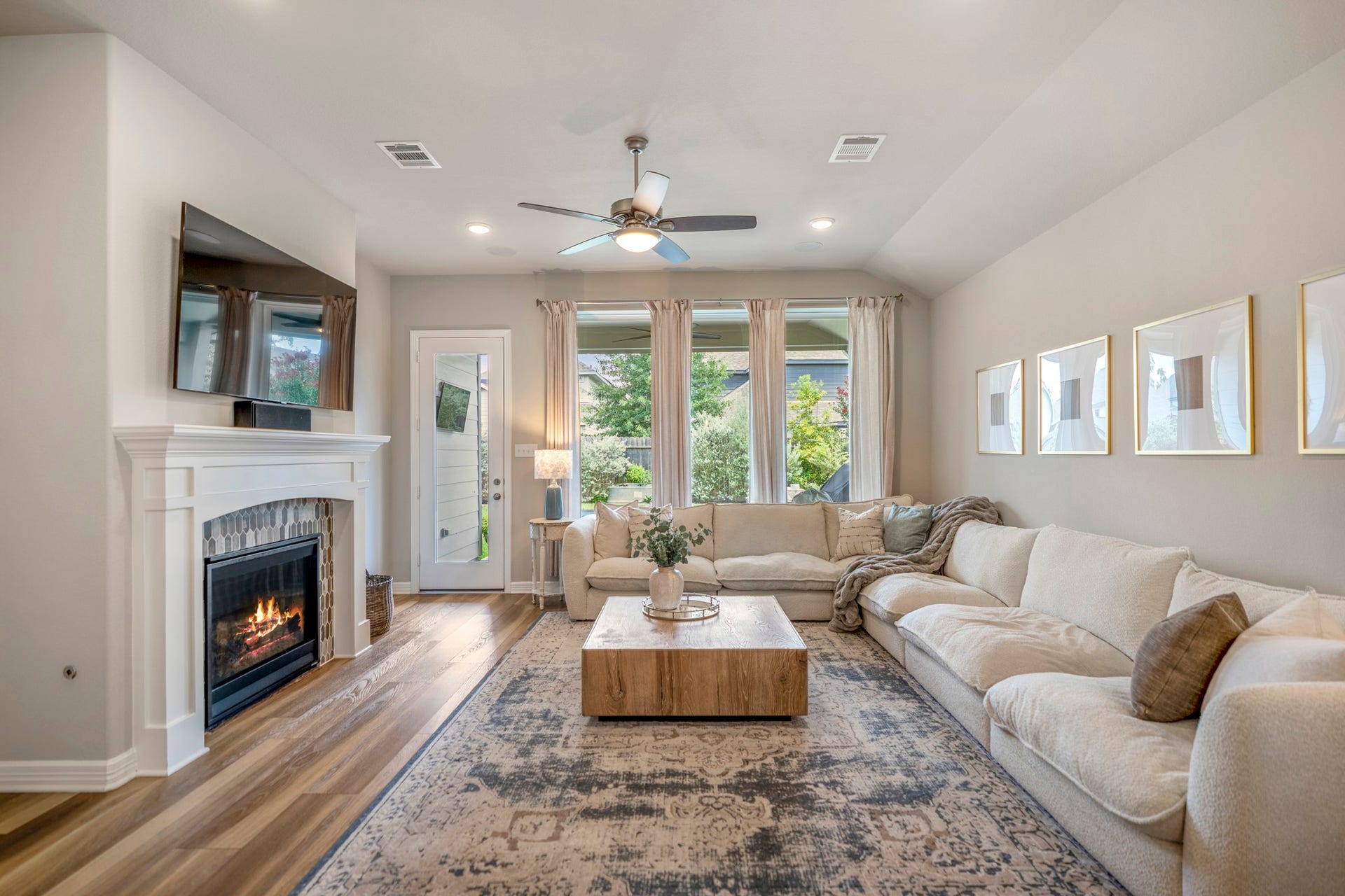 Living room includes built-in surround sound and beautiful mosaic tiled fireplace.