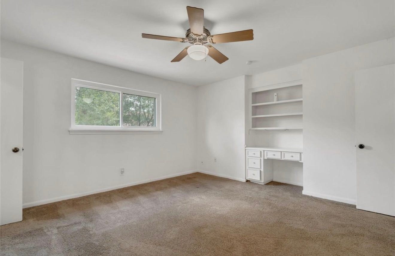 10818 Elmdale Drive, Houston, TX 77070 Upstairs secondary primary suite offering a private retreat with natural light, built-in shelving, and an en-suite bath, creating a well-appointed second primary space.