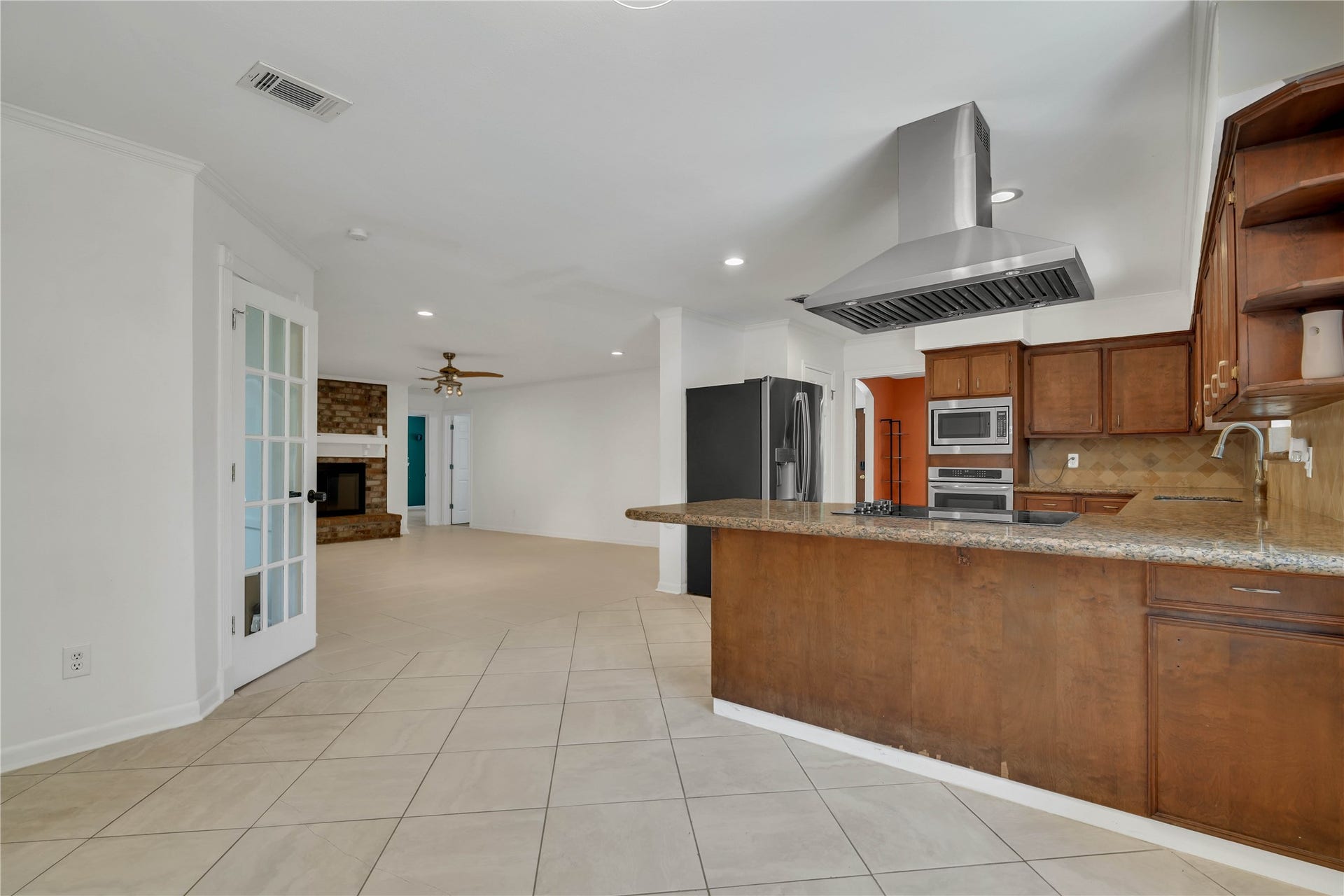 10818 Elmdale Drive, Houston, TX 77070 An inviting view from the breakfast area captures the homes impressive flow, with the living room extending ahead, the sunroom positioned to the left, and the kitchen anchoring the space to the right.