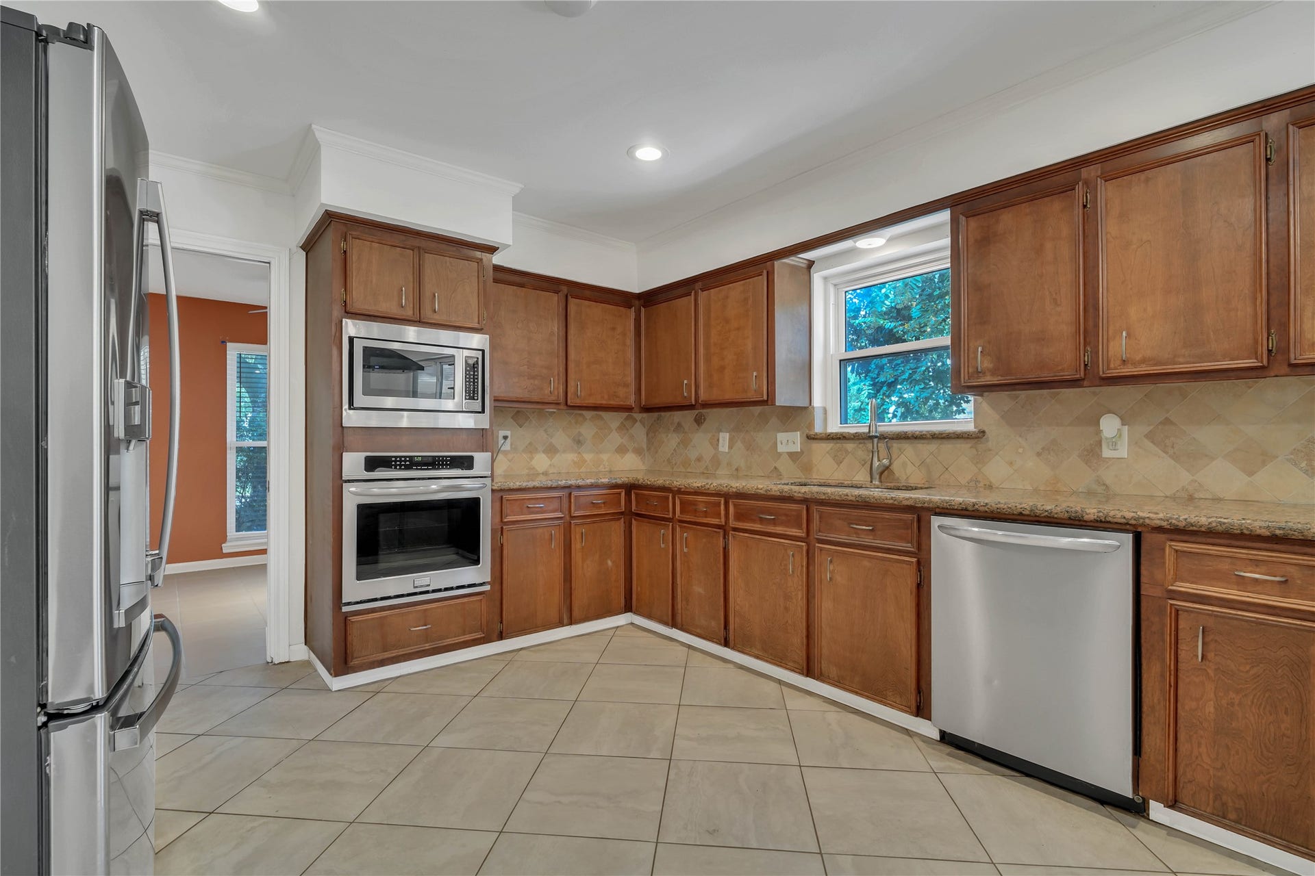 10818 Elmdale Drive, Houston, TX 77070 Another perspective highlighting the granite countertops, extensive cabinetry, and built-in double ovens.