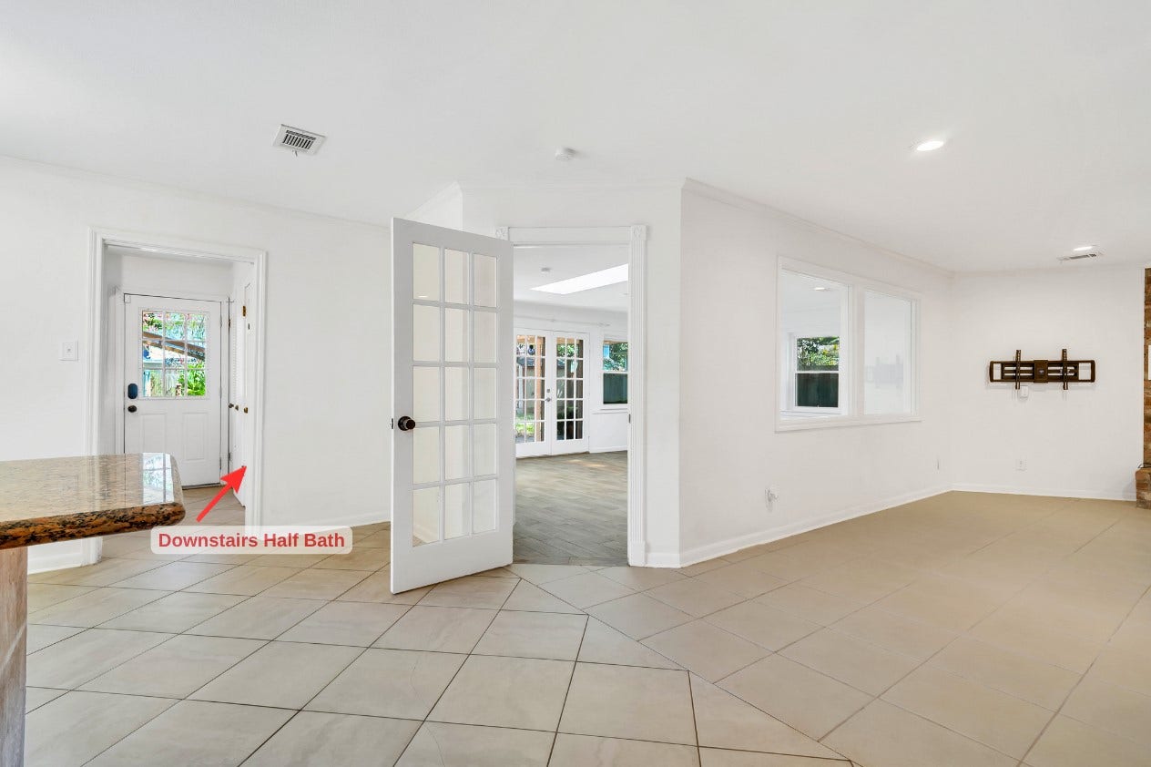 10818 Elmdale Drive, Houston, TX 77070 View from the kitchen showcases the expansive living room and its inviting connection to the sunroom beyond, creating an impressive layout for entertaining and everyday living.