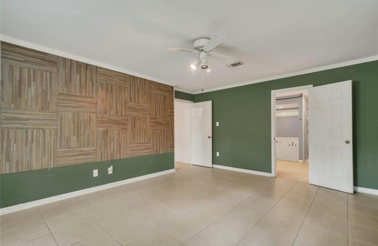 10818 Elmdale Drive, Houston, TX 77070 This perspective highlights the primary bedrooms distinctive accent wall and direct access to the private primary bath.