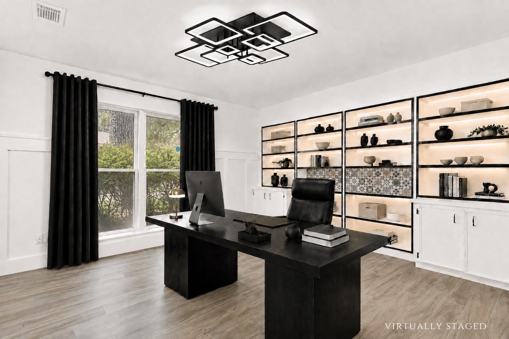 10818 Elmdale Drive, Houston, TX 77070 Virtually staged to showcase the impressive scale of this downstairs office, with ample room for a substantial executive desk complemented by the extensive built-in shelving and cabinetry.