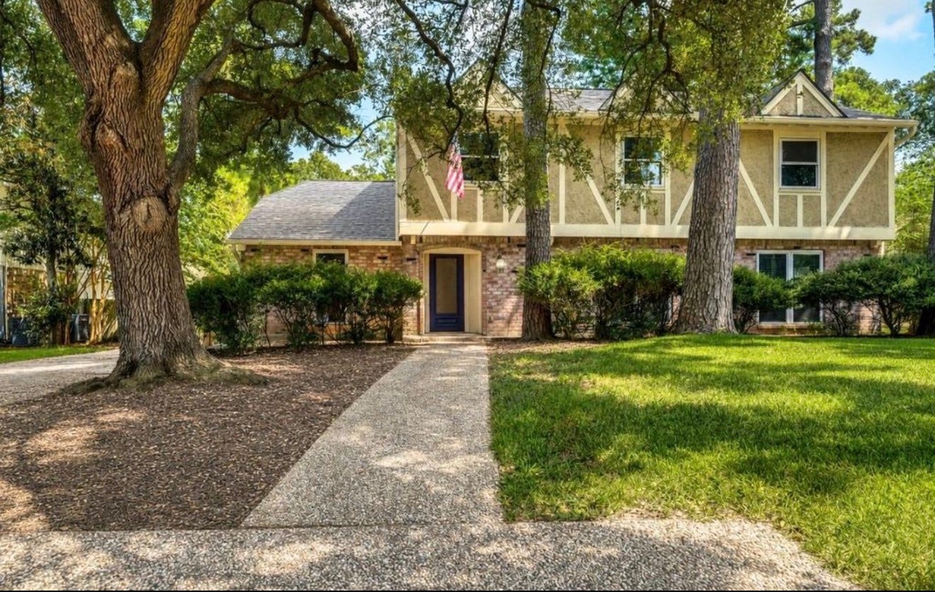 10818 Elmdale Drive, Houston, TX 77070 Closer perspective highlighting the homes welcoming approach, mature landscaping, and tree-lined front yard.