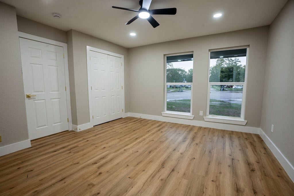 9856 Oriole, Conroe, TX 77385 Bright and inviting room with wood style flooring, dual windows for natural light, and ample closet space.