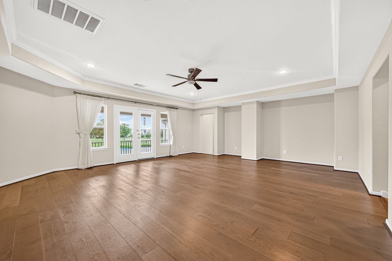 Generous upstairs game room opening to a balcony with stunning lake views.
